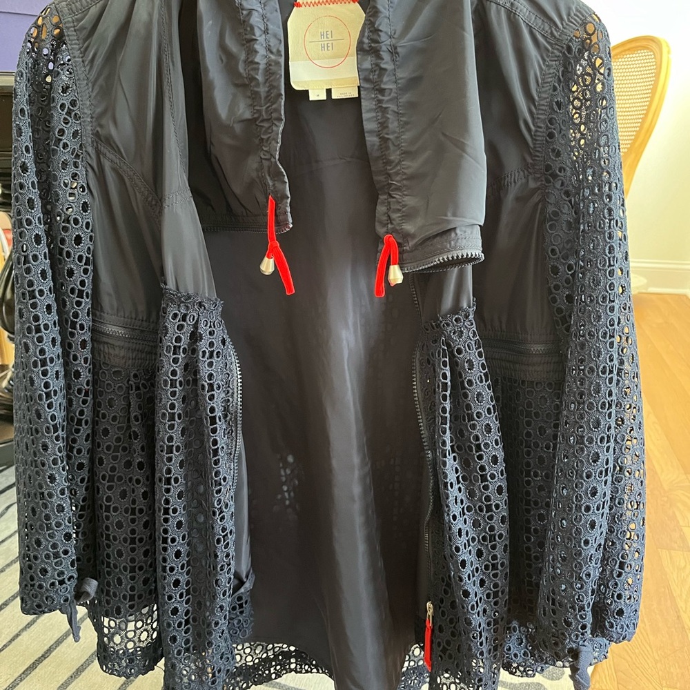 Navy blue, spring jacket with red accents on zippers. Eyelet sleeves and body